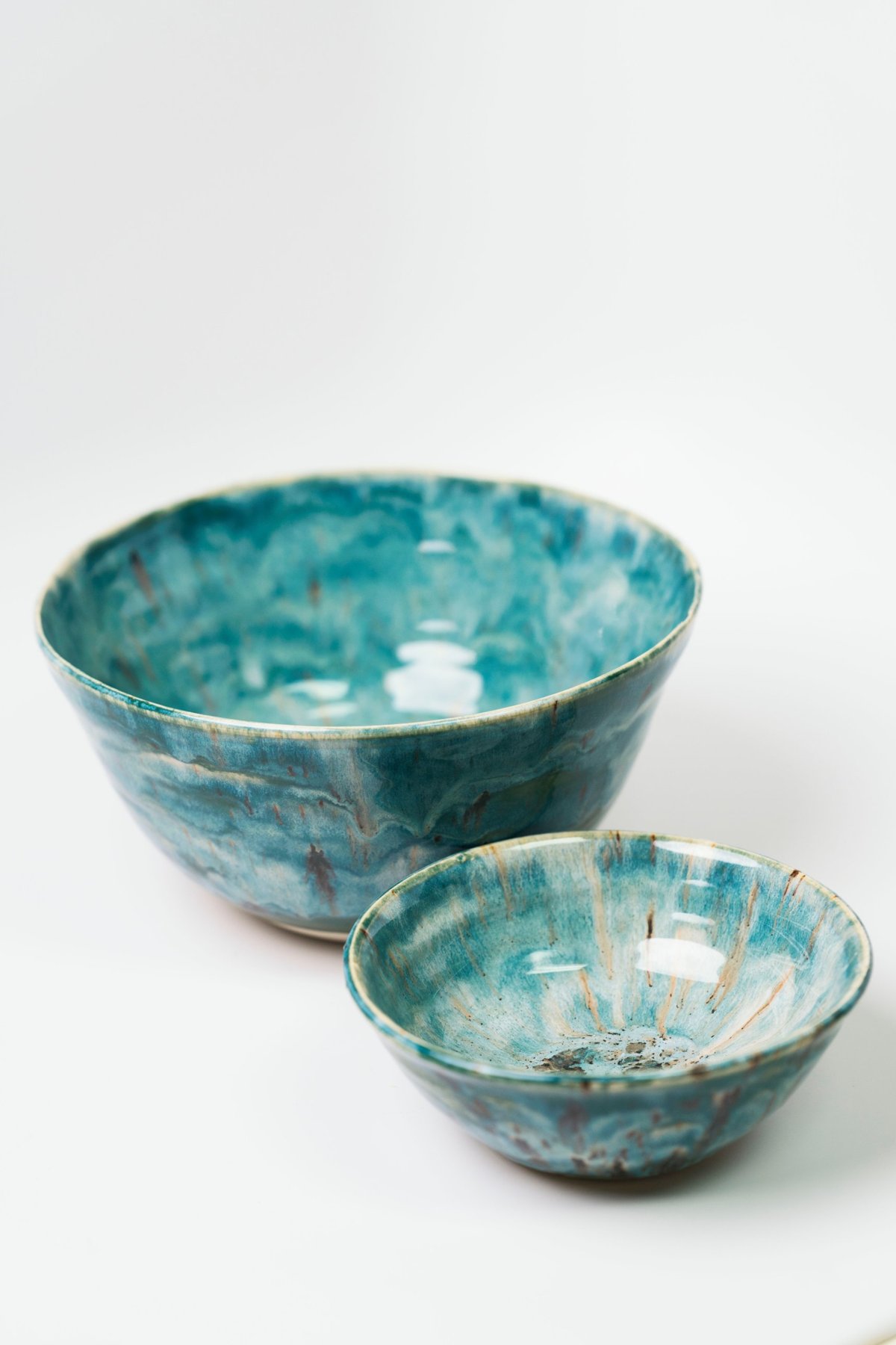 Large salad bowl and a smaller side bowl in a mottled teal-green glaze